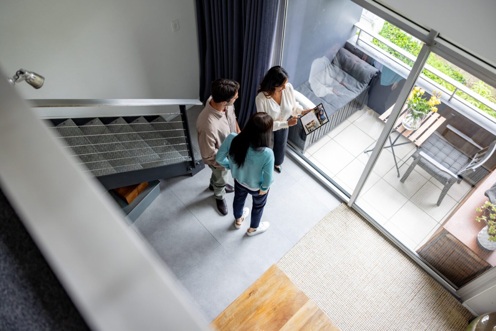 People viewing a modern apartment's balcony area.