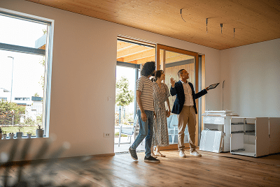 Real estate agent showing couple new home.